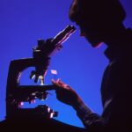 Généticien qui regarde dans un microscope